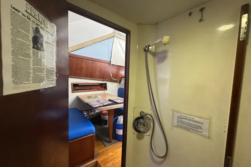Slide: The Image of Interior of 1991 Ocean Yachts 35 Super Sport, featuring shower and dining area. - 50
