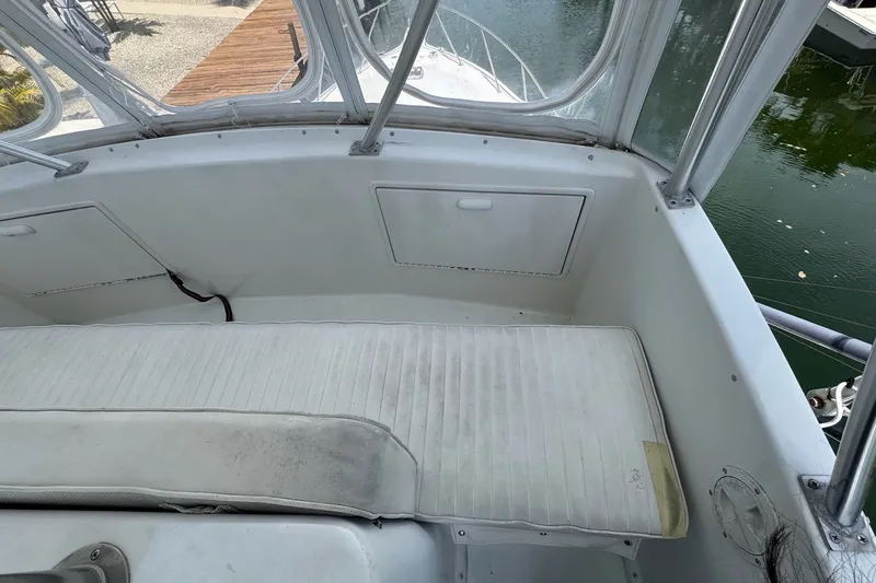 Slide: The Image of 1991 Ocean Yachts 35 Super Sport boat interior with white seating and windows. - 25