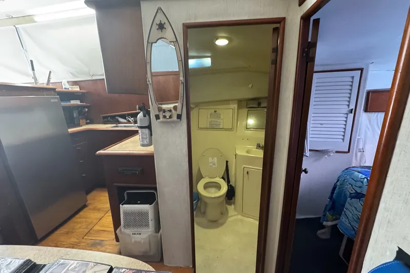 Slide: The Image of Interior of 1991 Ocean Yachts 35 Super Sport, featuring kitchen and bathroom areas. - 49