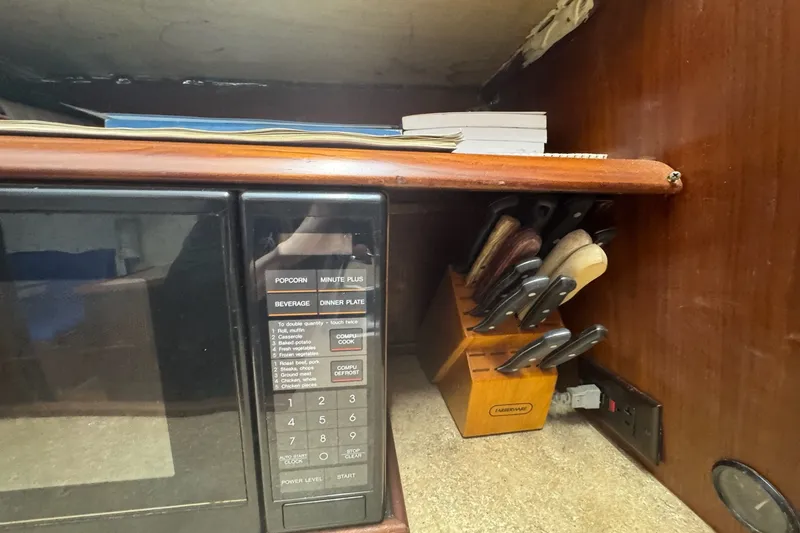 Slide: The Image of Microwave and knife block in 1991 Ocean Yachts 35 Super Sport kitchen area. - 43