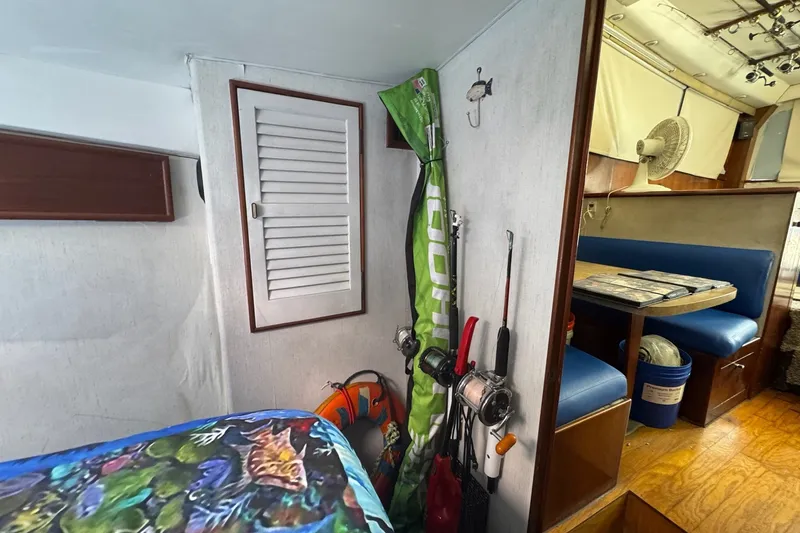 Slide: The Image of Interior of 1991 Ocean Yachts 35 Super Sport with fishing gear and dining area. - 56