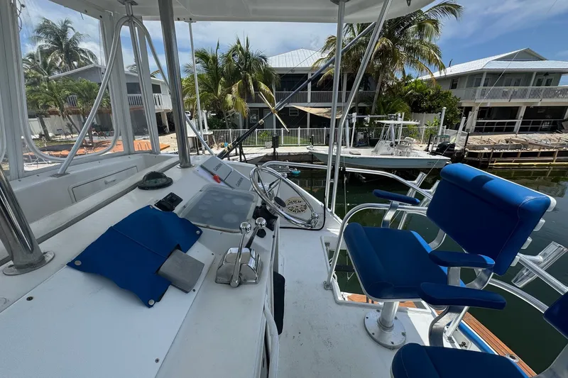 Slide: The Image of Cockpit view of 1991 Ocean Yachts 35 Super Sport with blue seating and steering wheel. - 14