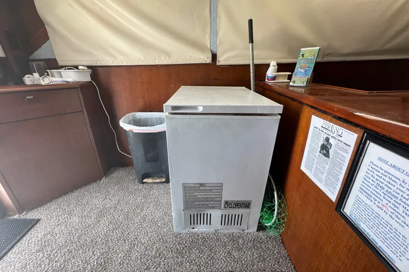Slide: The Image of Freezer inside 1991 Ocean Yachts 35 Super Sport boat cabin with fishing gear. - 36