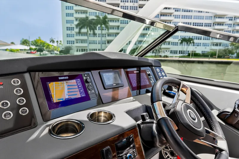 Slide: The Image of 2023 Chaparral 280 OSX boat dashboard with navigation screens and steering wheel. - 46