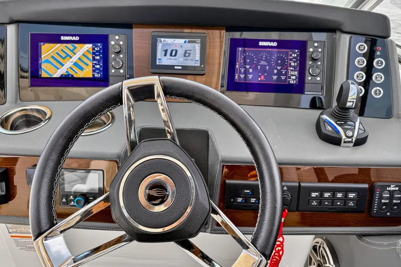 Slide: The Image of 2023 Chaparral 280 OSX helm with advanced Simrad navigation displays and joystick controls. - 65