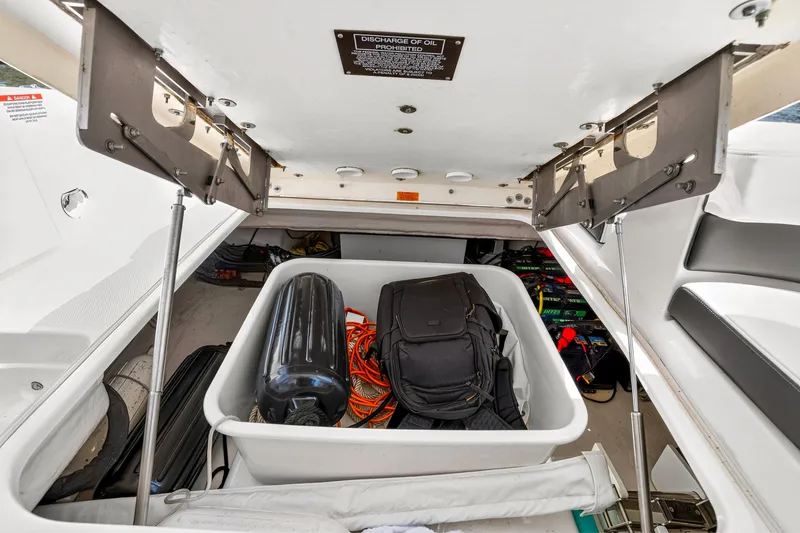 Slide: The Image of Storage compartment of 2023 Chaparral 280 OSX boat with gear and equipment. - 77