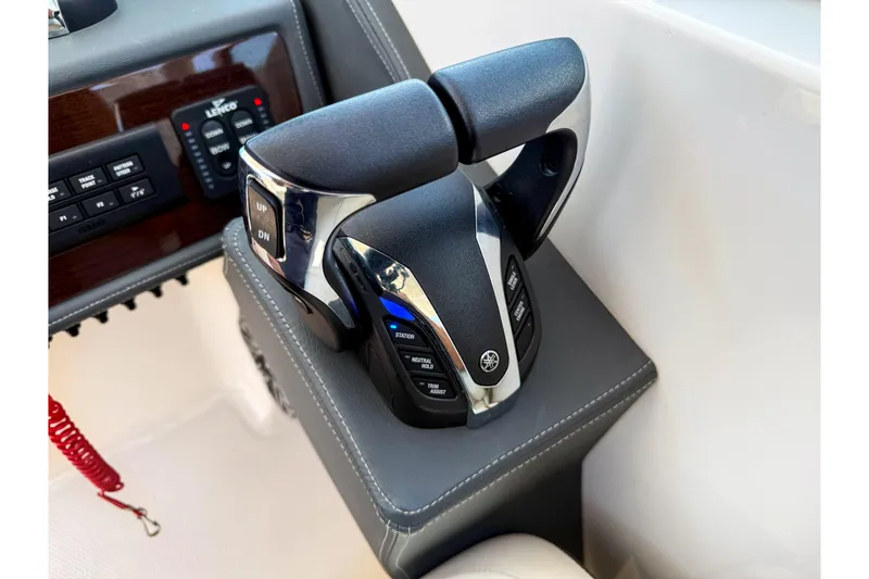 Slide: The Image of Throttle controls on a 2023 Chaparral 280 OSX boat dashboard. - 64