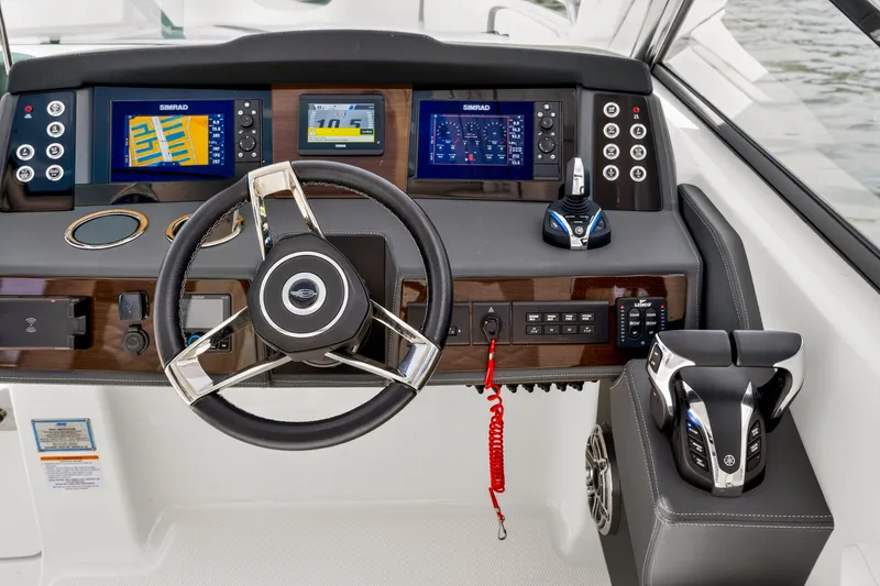 Slide: The Image of 2023 Chaparral 280 OSX helm with advanced navigation displays and controls. - 54