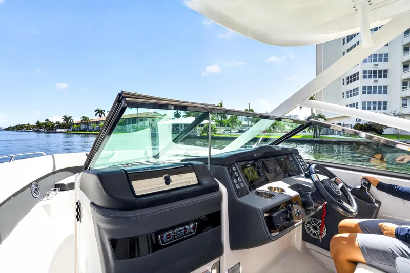 Slide: The Image of 2023 Chaparral 280 OSX boat interior with modern dashboard and waterfront view. - 44