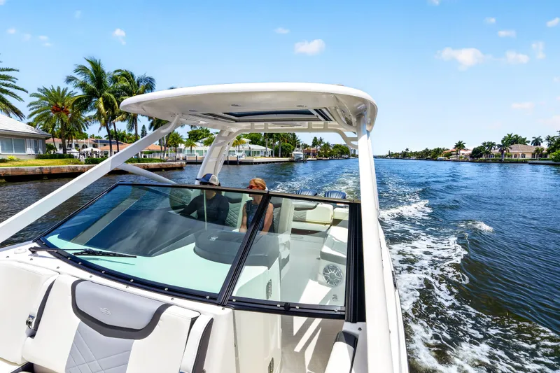 Slide: The Image of 2023 Chaparral 280 OSX cruising on a sunny waterway with palm trees. - 67