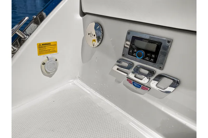 Slide: The Image of 2023 Chaparral 280 OSX boat dashboard with stereo and model emblem. - 75