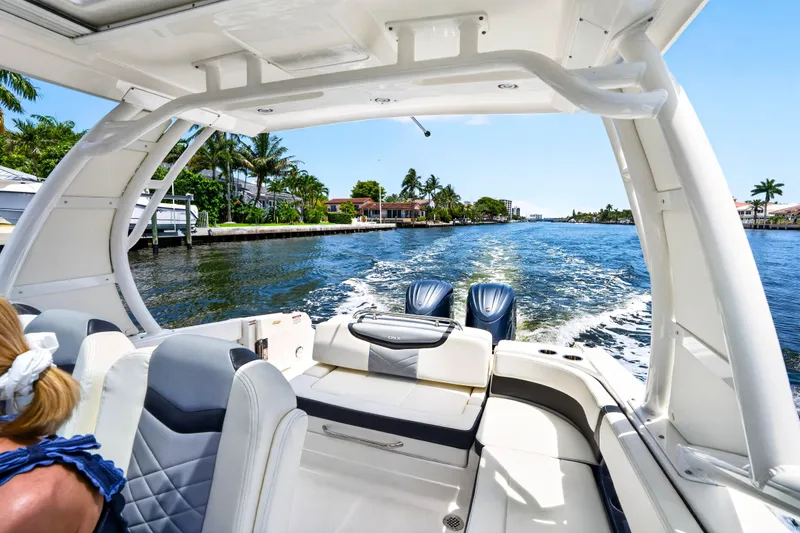Slide: The Image of 2023 Chaparral 280 OSX cruising on a scenic waterway with palm trees. - 28