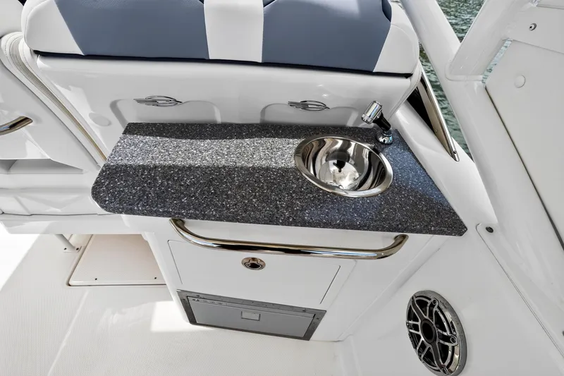 Slide: The Image of 2023 Chaparral 280 OSX boat interior with sleek countertop and stainless steel sink. - 20