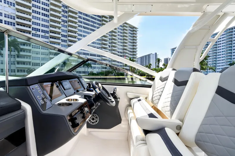 Slide: The Image of 2023 Chaparral 280 OSX boat interior with modern dashboard and luxurious seating. - 50
