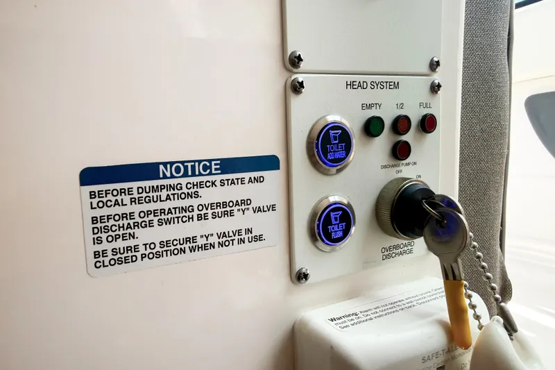 Slide: The Image of Control panel of 2023 Chaparral 280 OSX boat's head system with operational instructions. - 41