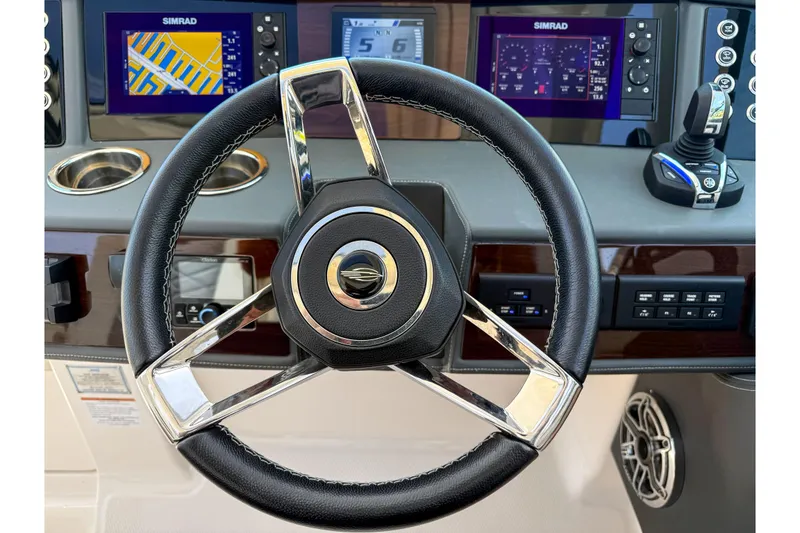 Slide: The Image of 2023 Chaparral 280 OSX boat dashboard with steering wheel and navigation displays. - 60