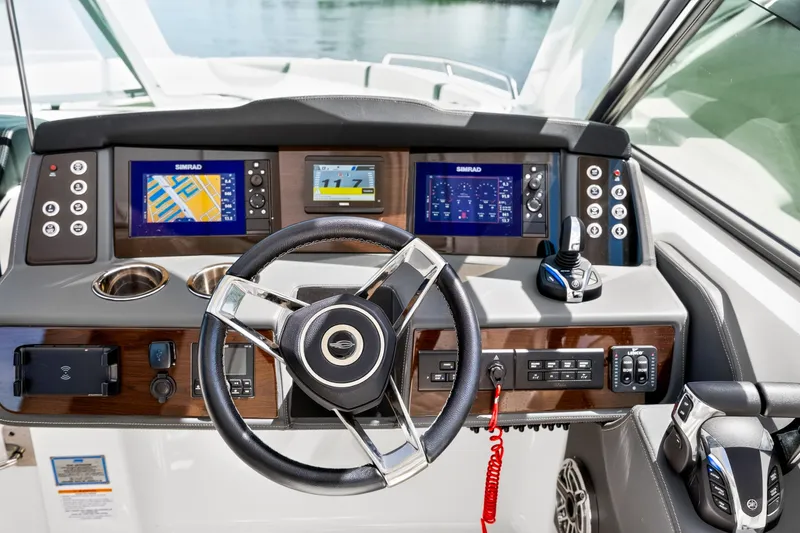 Slide: The Image of 2023 Chaparral 280 OSX boat dashboard with advanced navigation displays and controls. - 48