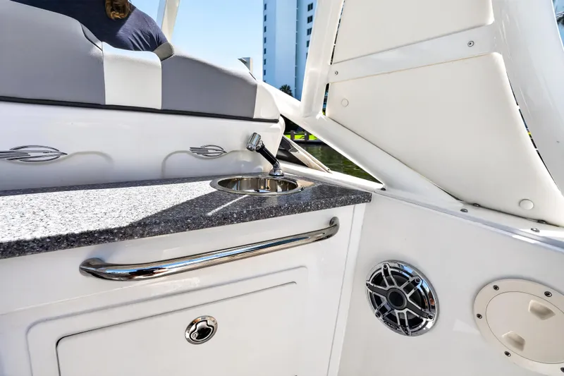 Slide: The Image of 2023 Chaparral 280 OSX boat interior with sink and speaker detail. - 24