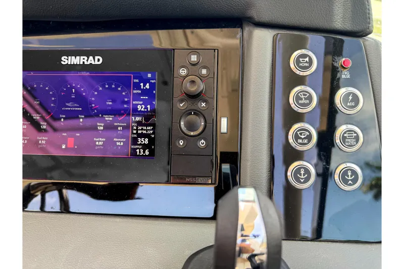 Slide: The Image of Control panel of 2023 Chaparral 280 OSX boat with Simrad display and buttons. - 62