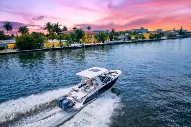 Slide: The Image of 2023 Chaparral 280 OSX cruising on a scenic waterway at sunset. - 82