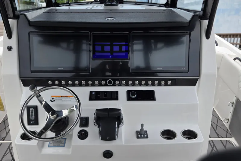 Slide: The Image of 2024 Fountain 32 NX Sportfish helm with dual screens and modern controls. - 24