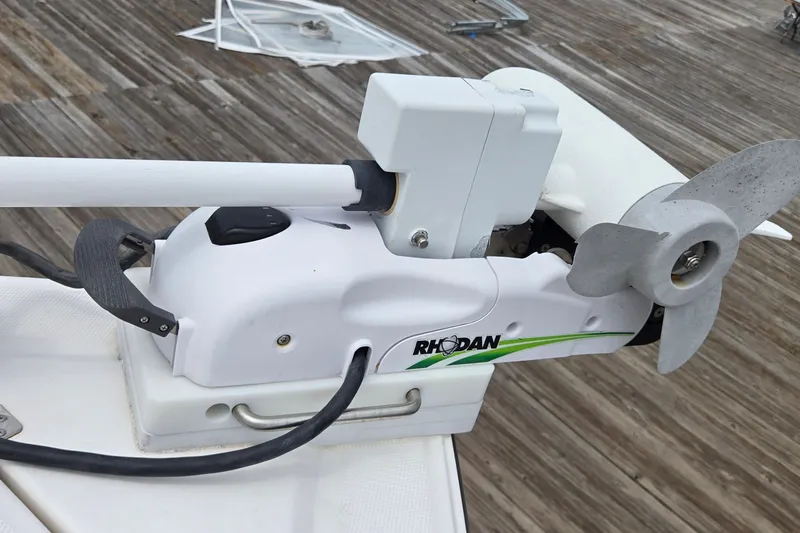 Slide: The Image of Rhodan trolling motor on 2024 Fountain 32 NX Sportfish boat, docked on wooden pier. - 42
