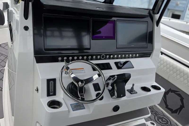 Slide: The Image of 2024 Fountain 32 NX Sportfish dashboard with dual screens and modern controls. - 23