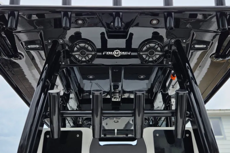 Slide: The Image of 2024 Fountain 32 NX Sportfish boat interior with sleek black design and audio system. - 36