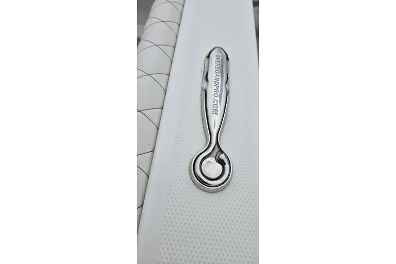 Slide: The Image of Chrome handle on 2024 Fountain 32 NX Sportfish boat with textured white surface. - 43