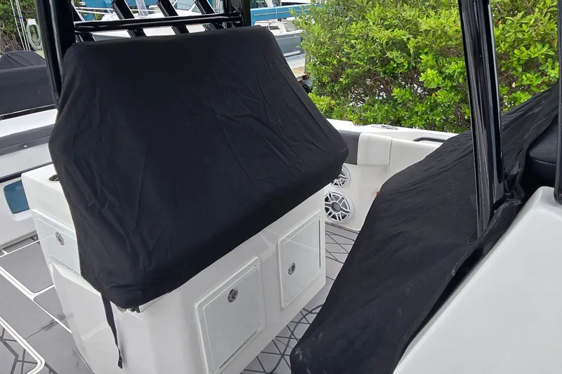 Slide: The Image of 2024 Fountain 32 NX Sportfish interior with covered seating and storage compartments. - 45