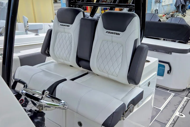 Slide: The Image of 2024 Fountain 32 NX Sportfish boat interior with luxurious seating and steering wheel. - 38