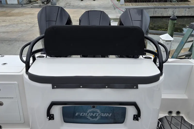 Slide: The Image of 2024 Fountain 32 NX Sportfish boat with triple outboard engines at dock. - 13