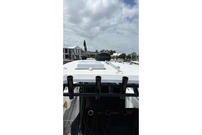 Slide: The Image of 2024 Fountain 32 NX Sportfish boat with Garmin equipment, docked under cloudy skies. - 39