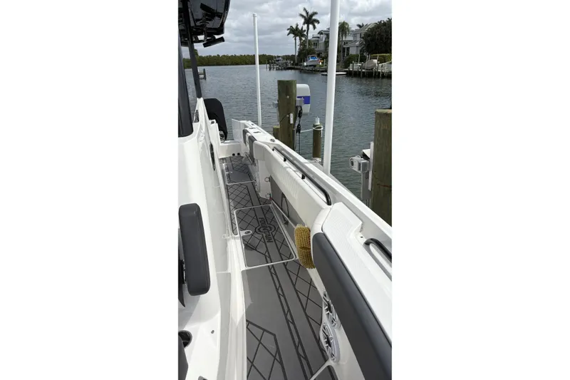 Slide: The Image of 2024 Fountain 32 NX Sportfish boat docked, showcasing sleek deck design and waterfront view. - 27