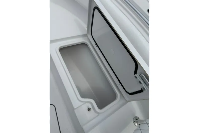 Slide: The Image of Open storage compartment on 2026 Sportsman Open 232 Center Console boat. - 31