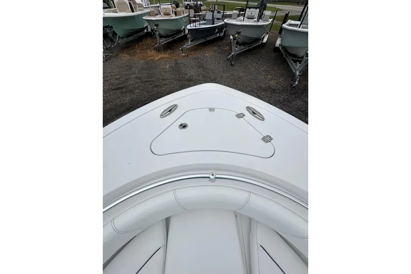 Slide: The Image of 2026 Sportsman Open 232 Center Console boat bow view, parked among other boats. - 27