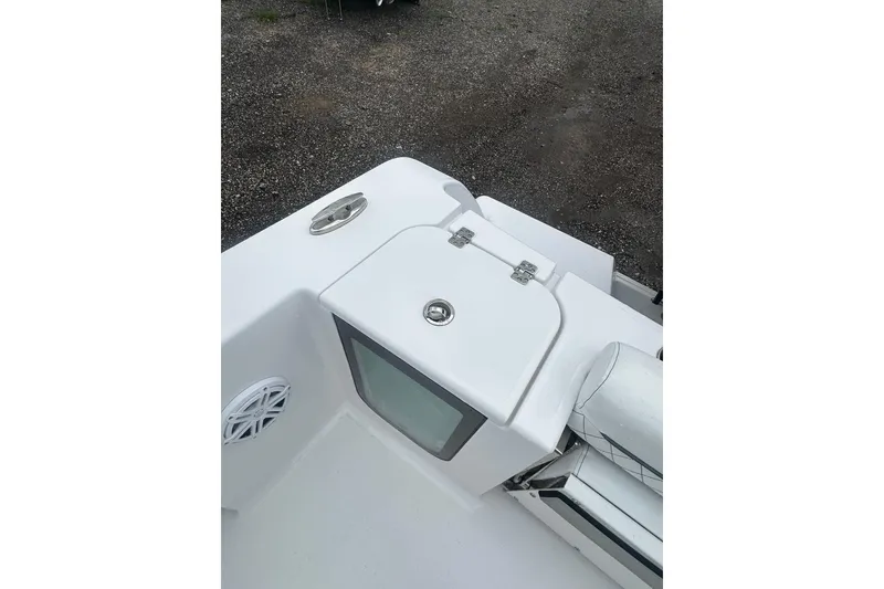 Slide: The Image of 2026 Sportsman Open 232 Center Console boat deck with storage compartment and speaker. - 18