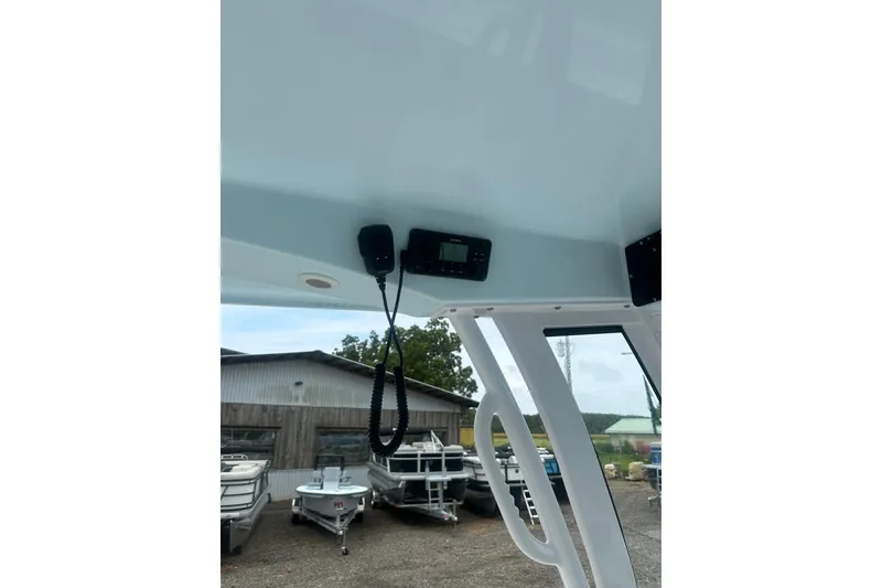 Slide: The Image of 2026 Sportsman Open 232 Center Console boat interior with radio equipment. - 13