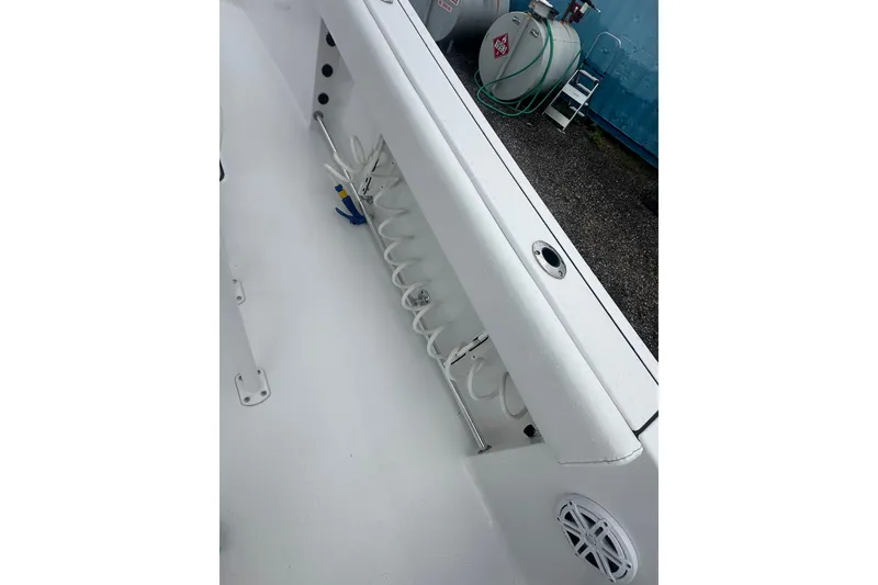 Slide: The Image of 2026 Sportsman Open 232 Center Console boat interior with rod holders and speaker. - 19