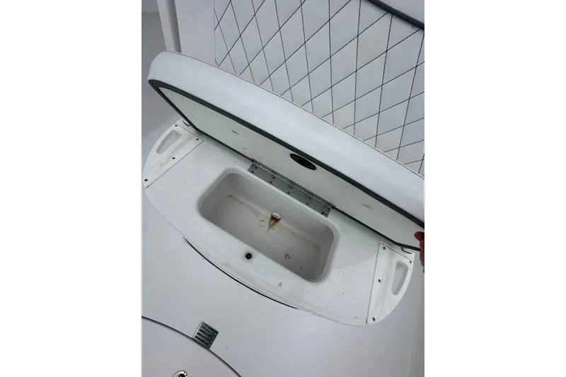 Slide: The Image of Open storage compartment on 2026 Sportsman Open 232 Center Console boat. - 22