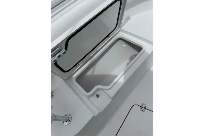 Slide: The Image of Open storage compartment on 2026 Sportsman Open 232 Center Console boat. - 29