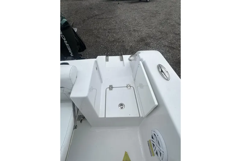 Slide: The Image of 2026 Sportsman Open 232 Center Console boat deck with storage compartment and speaker. - 17
