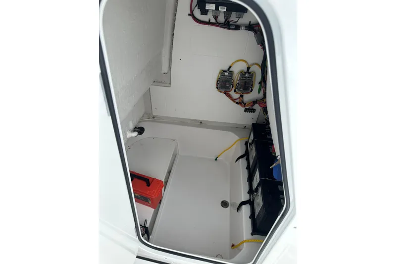 Slide: The Image of Interior view of 2026 Sportsman Open 232 Center Console boat's electrical compartment. - 34