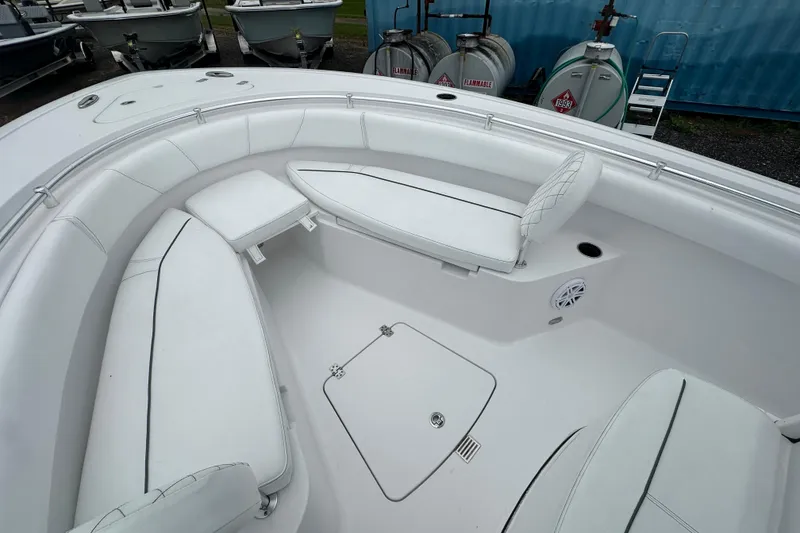 Slide: The Image of 2026 Sportsman Open 232 Center Console boat interior with white cushioned seating. - 25