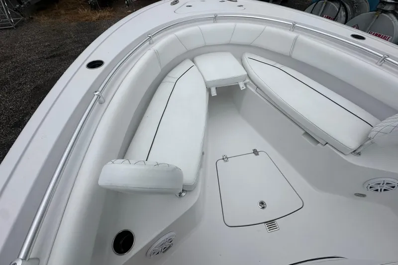 Slide: The Image of 2026 Sportsman Open 232 Center Console boat interior with white cushioned seating. - 24