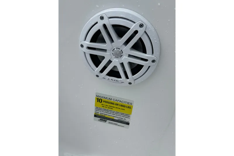 Slide: The Image of Speaker and capacity label on 2026 Sportsman Open 232 Center Console boat. - 45
