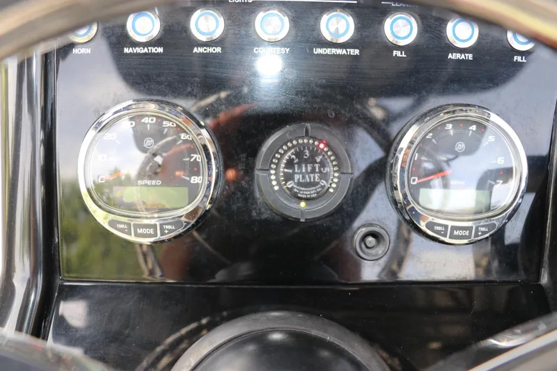 Slide: The Image of Dashboard of a 2018 ShearWater 25 LTZ boat with speedometer and RPM gauges. - 26