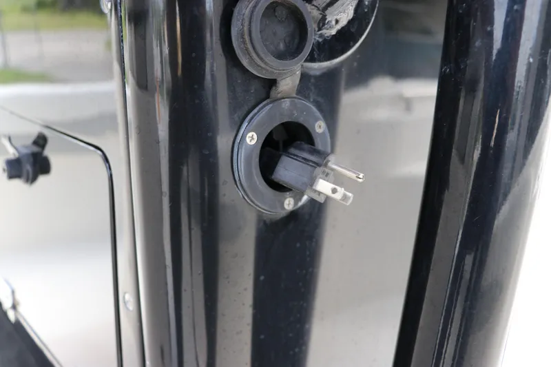 Slide: The Image of Close-up of a 2018 ShearWater 25 LTZ boat's electrical plug socket. - 30