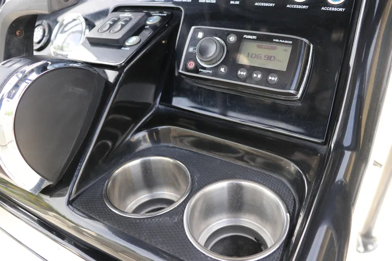 Slide: The Image of Dashboard of 2018 ShearWater 25 LTZ boat with radio and cup holders. - 24