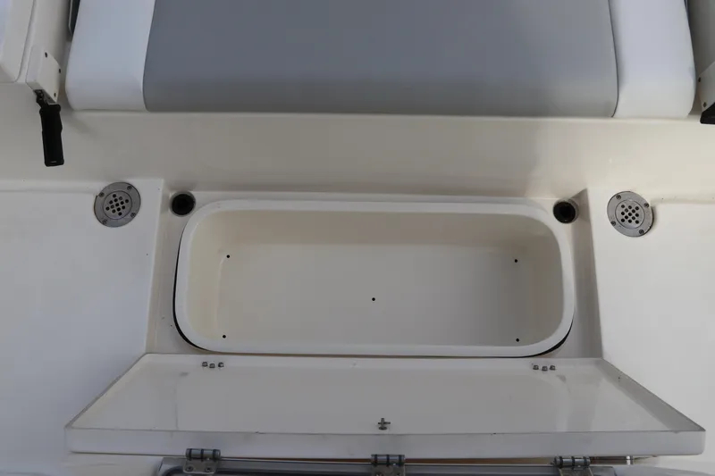 Slide: The Image of 2018 ShearWater 25 LTZ boat storage compartment with open lid and seating area. - 15